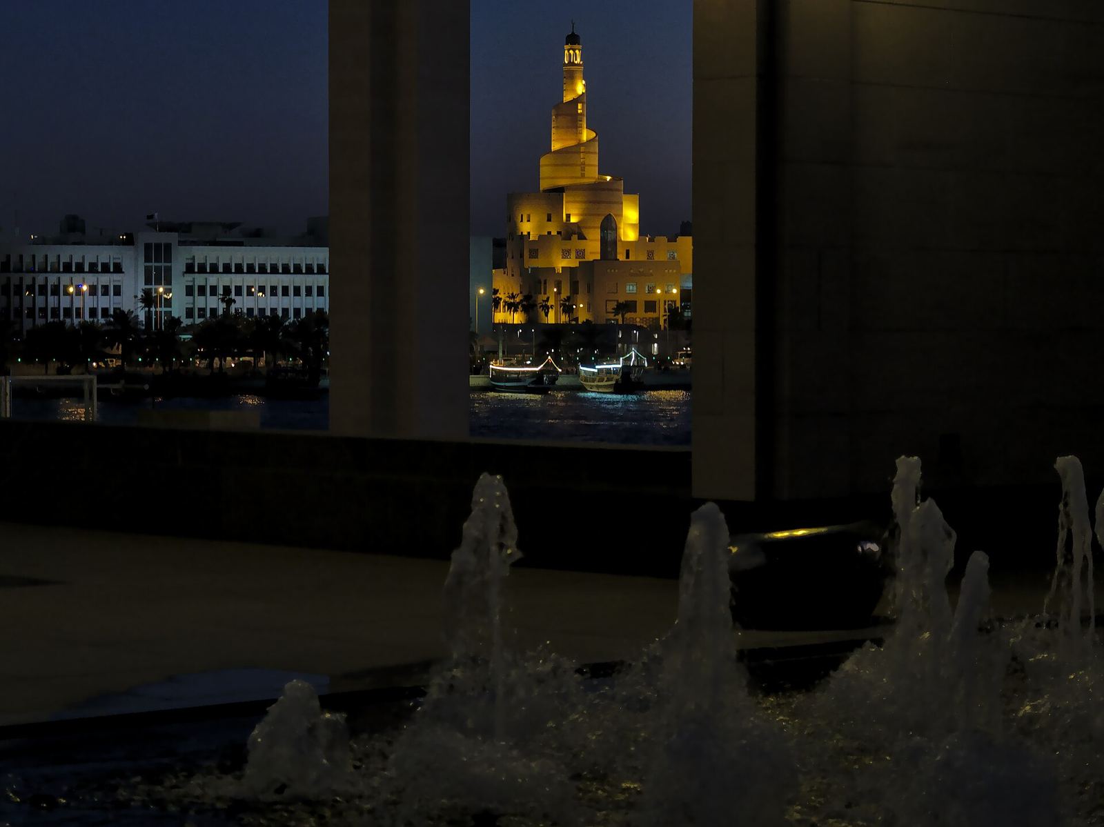 Doha's spiral-minaret mosque at night, from the museum park