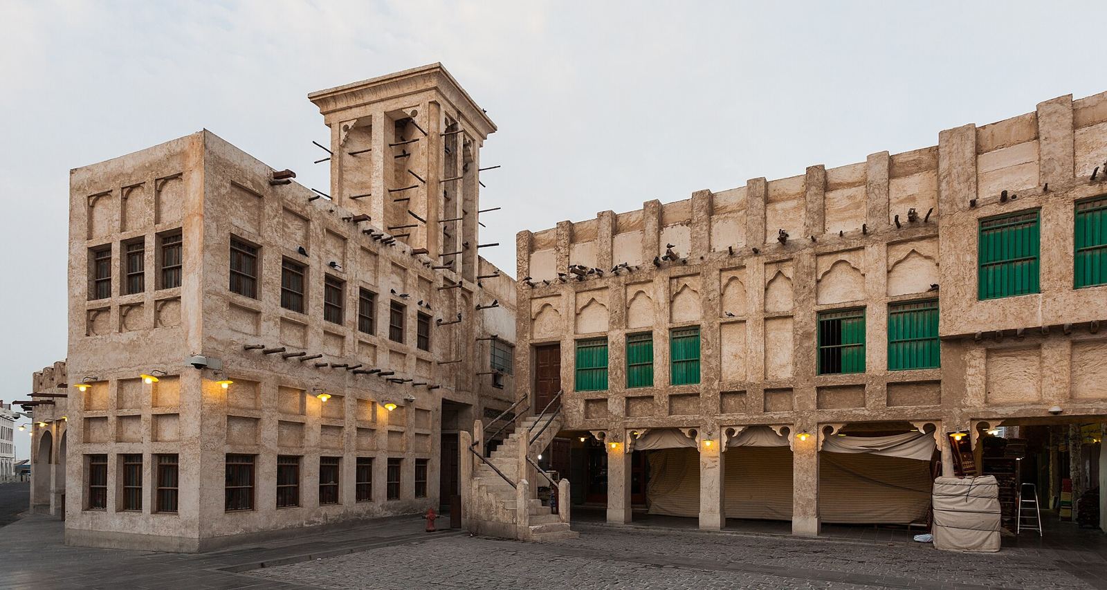 Old merchant buildings and a wind tower in Souq Waqif, Doha